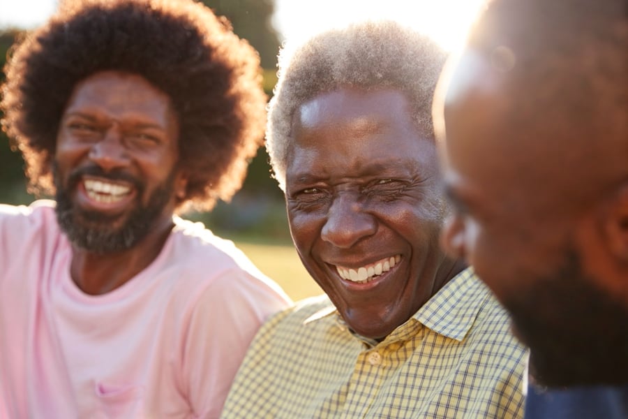 Three men laughing with each other
